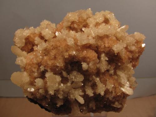 Stilbite + Chabazite
Moonen Bay, Isle of Skye, Scotland, UK
9cm x 7cm x 4 cm
Stilbite crystals to 10mm+, and in aggregates of tiny transparent crystals, on a bed of small pink chabazites. One of the best specimens recovered from an almost pristine large cavity - in fact they were so clean they almost didn’t need cleaning. The pink colour of the chabazite seems to be stable. I have found this combination of zeolites here before but nothing of this quality. (Author: Mike Wood)