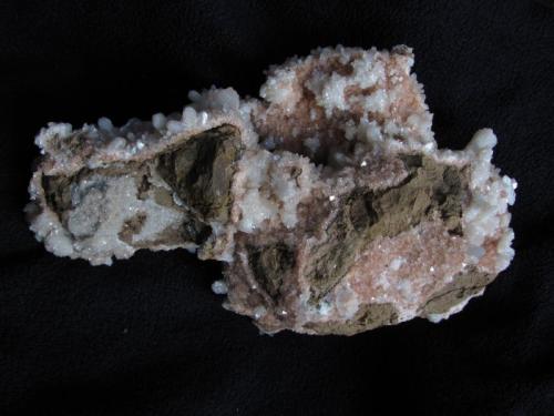 Stilbite + Chabazite
Moonen Bay, Isle of Skye, Scotland, UK
19cm x 12cm x 8cm
The other side of the specimen showing the basalt matrix and areas of pink chabazite and scattered stilbite crystal groups. (Author: Mike Wood)