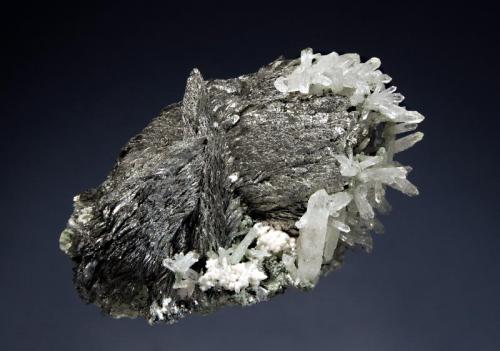 Löllingite
Huanggang Mine #5,  Keshiketeng Co., Chifeng Pref., Inner Mongolia AR, China
5.2 x 7.1 cm
Polycrystalline growths of spear-shaped, lustrous, silvery löllingite crystals with quartz and minor dolomite. (Author: crosstimber)