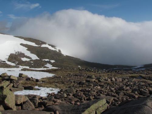 The next morning I walked back to base where I’d left my car at the Cairngorm Ski Centre. The fog came back with a vengeance and the wind blew strong, but I spied out the route before the view was obscured and used a map and compass. After about an hour I came across a large familiar footpath which led me safely off the mountain. I decided to return when there was less snow, which I did six weeks later for one superb day in July. (Author: Mike Wood)