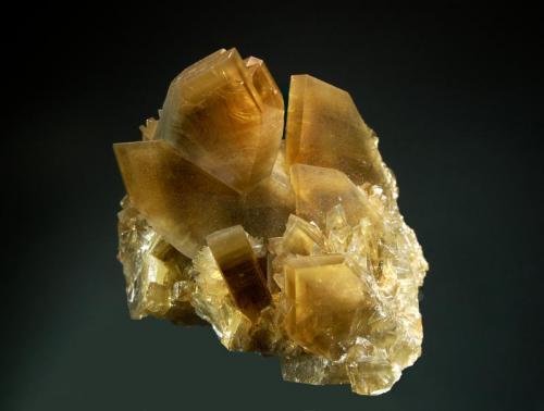 Barite
Xichang Co., Liangshan Aut. Pref., Sichuan Prov. China
7.2 x 8.5 cm
Sharp, chiesel-shaped, golden-brown, barite crystals with steep terminations and subtle color zoning. (Author: crosstimber)