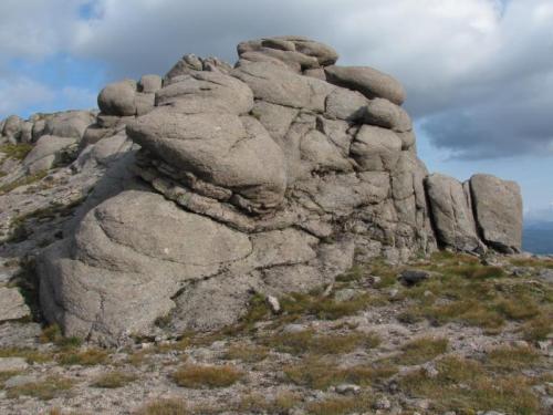 A typical pegmatite vein in the granite of Ben a’ Bhuird, this one is a bit larger than is usual for the locality, but was lacking in euhedral crystals.
 The outcrop is approximately 10m high. (Author: Mike Wood)