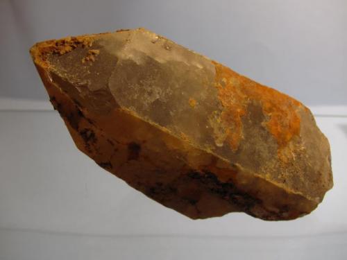 Quartz
Shelter Stone Crag, Caingorm Mountains, Grampian Region, Scotland, UK
70mm x 35mm x 30mm
A fairly large but rough looking quartz crystal. It is somewhat translucent and not smoky, and appears to have an overgrowth or second generation of quartz. Found this and several small crystals near the top of Shelter Stone Crag, by carefully climbing down a ’bottomless’ gully a short distance (not the gully in the previous photo). Couldn’t do much poking about as I was acutely aware of the sickening drop below me, and the possibility of climbers somewhere below. (Author: Mike Wood)