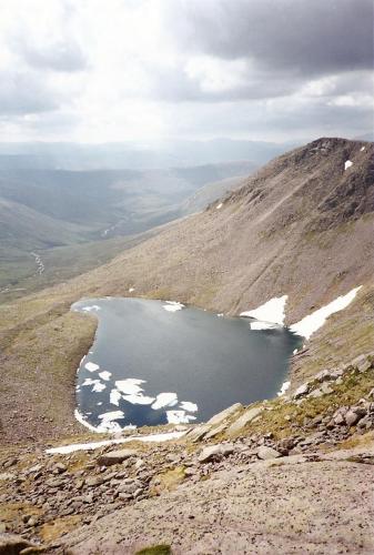 Lochan Uaine, about 1.5km southeast of Ben Macdui in the Cairngorms, one of the highest lochans (small lake) in the UK at over 950m above sea level. But even I was surprised to see icebergs floating on it, in late June!! Don’t know for sure if it contains trout, but I bet it does.
Photo taken June 1994 (scanned from print), M.Wood. (Author: Mike Wood)