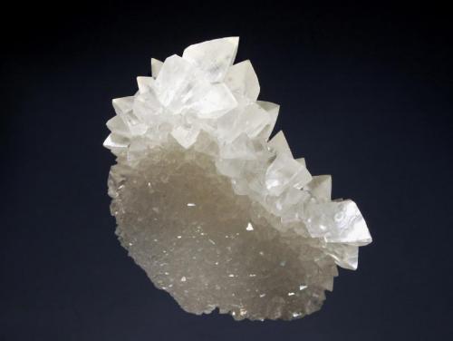 Calcite
Wenshan Mine, Wenshan Co., Yunnan Prov., China
5.7 x 7.3 cm
A thin plate composed of small colorless calcite crystals with a second generation of larger scalenohedral calcites lining the top of the plate. (Author: crosstimber)