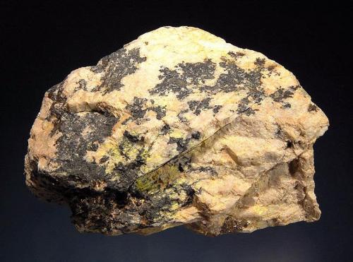 Uraninite
Ruggles Mine, Grafton, Grafton Co., New Hampshire, USA
5.0 x 7.5 cm
Black uraninite and minor yellow autunite on a light-colored feldspar matrix. (Author: crosstimber)