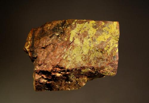 Autunite
Ruggles Mine, Grafton, Grafton Co., New Hampshire, USA
5.1 x 7.5 cm
Bright yellow crusts and lustrous platy micro-crystals of autunite on brownish feldspar with minor black uraninite. (Author: crosstimber)