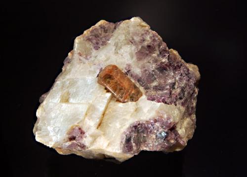 Fluorapatite
Fission Mine, Cardiff Township, Halliburton Co., Ontario, Canada
6.7 x 8.4 cm
A crystal of brown fluorapatite embedded in colorless calcite with purple fluorite. (Author: crosstimber)