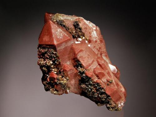 Quartz
Messina Mine, Limpopo Prov., South Africa
6.0 x 7.3 cm
Doubly-terminated quartz crystals colored reddish-brown by hematite inclusions with small black hematite crystals coating several prism faces. (Author: crosstimber)