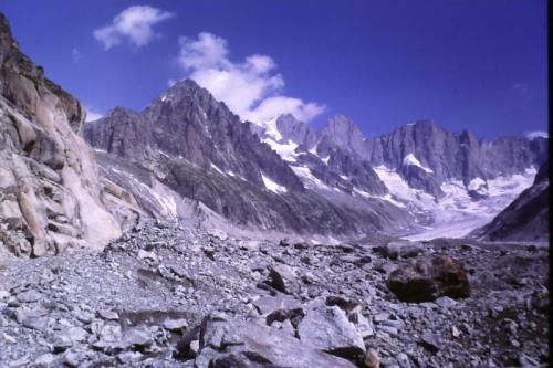 The way follows the Glacier de Leschaux for a little distance; where this glacier meets the Mer de Glace there are a lot of rocks about. (Lateral moraine?). I stopped to examine some of these boulders and found tiny crystals of pink fluorite in places.
Photo scanned from slide. (Author: Mike Wood)