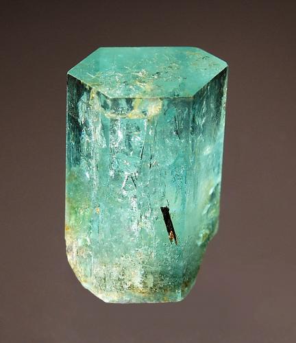 Beryl var. aquamarine
Bersig Farm 167, Omaruru Dist., Erongo region, Namibia
2.1 x 2.7 cm
A hexagonal prism of aquamarine with a pinacoid termination and minor schorl in association. (Author: crosstimber)