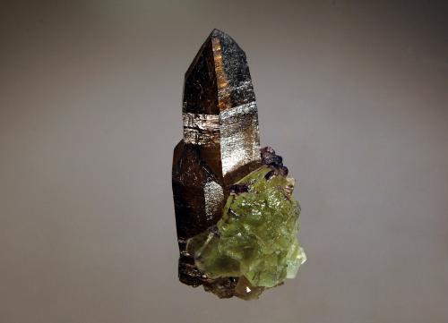 Fluorite on smoky quartz
Erongo Mts., Erongo Region, Namibia
2.6 x 4.9 cm
Cube-octahedral green fluorite crystals partially surrounding the base of two smoky quartz crystals in parallel growth. (Author: crosstimber)