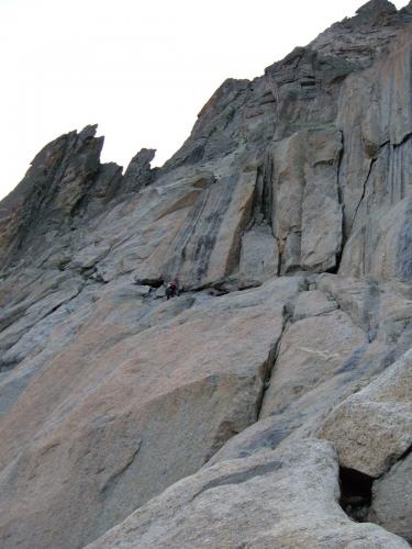 Myself and Colin set off to climb Aiguille du Moine. The climbing is steep and airy, but relatively easy. Colin was refreshed by his luxurious night’s sleep in the hut and was way out in front - you can see him working his way leftwards along some sloping ledges. Actually I think at that point he waited for me ’cos a rope was required... (Author: Mike Wood)