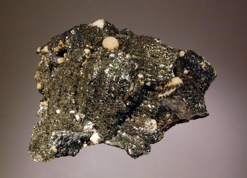 Pyrite ps. after pyrrhotite
Trepca Complex, Kosovska-Mitrovica, Kosovo
7.6 x 8.7 cm
Thin bladed pyrrhotite crystals replaced by bright micro crystals of pyrite associated with pale tan calcite spheres and minor galena. (Author: crosstimber)