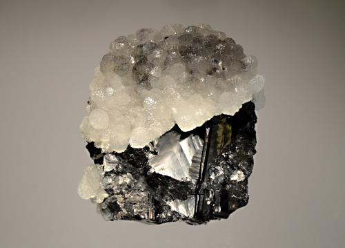 Sphalerite and calcite
Trepca Complex, Kosovska-Mitrovica, Kosovo
7.2 x 8.5 cm
Lustrous complex crystal of sphalerite capped by colorless calcite crystals. (Author: crosstimber)
