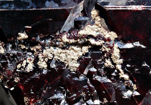 Cuprite with silver
Poteryaevskoe Mine, Rubtsovskoe Cu-Zn-Pb deposit, Rudnyi Altai, Western-Siberian Region, Russia
3.0 x 3.7 cm, FOV ~ 0.6 cm
The same crystal as above showing crudely crystallized native silver growing amongst the cuprite. (Author: crosstimber)