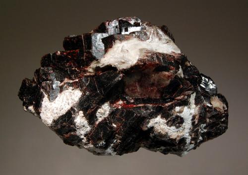 Villiaumite
Koashva Mt., Khibiny Massif, Kola Peninsula, Murmanskaya Oblast, Russia
5.5 x 6.6 cm
Wine-red cleavages of the rare halide, villiaumite to 1.3 cm embedded in white natrolite. (Author: crosstimber)