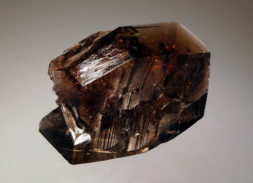 Axinite-(Fe)
Puiva Mount, Saranpaul, Tyumenskaya Oblast, Prepolar Ural, Western Siberian Region, Russia
3.1 x 4.5 cm
Glassy sharp brown bladed crystal of axinite-(Fe). (Author: crosstimber)