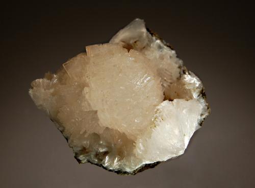 Thomsonite-(Ca)
Amudikha River, Evenkia, Krasnoyarsk Territory, Eastern-Siberian Region, Russia
4.5 x 5.8 cm
Spherical aggregate of pale pink thomsonite crystals adjacent partial spheres showing the radial crystal structure. (Author: crosstimber)