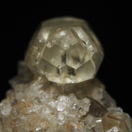 Twinned calcite crystal on fluorite
Longstone Edge, Derbyshire, England, UK
Calcite twin ~ 10 mm long. Collected 22/08/1998 from a limestone boulder at the side of the access road leading to the then active workings on the Bow and Deep Rake veins. (Author: Andy Lawton)