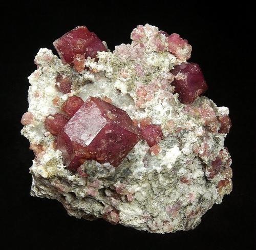 Grossular
Sierra de Cruces, Municipio de Sierra Mojada, Coahuila, Mexico
64 x 57 x 41 mm
Several raspberry Grossular garnets, the largest measuring 22 x 21 mm, are perched on typical matrix. This is large for the locality, and is in good condition. (Author: GneissWare)