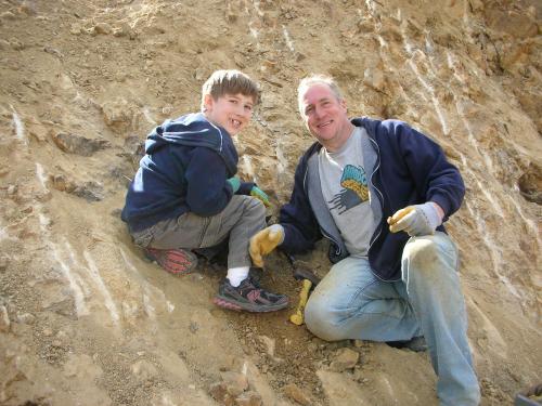Portland, Oregon father-son collectors Jack (left) and Floyd (right) enjoying the dig.  Son Jack found a very clear amethyst scepter point in the pocket, undamaged, and the point of the scepter in the amethyst head could clearly be seen.  Floyd is one of the owners of Jackson Crossroads in Georgia. (Author: Tony L. Potucek)