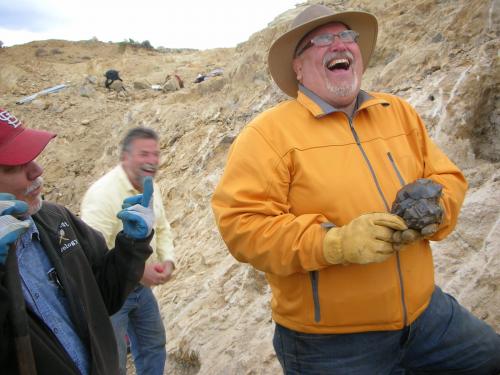 John Veevaert on the left is expressing his "disappointment" to mucho ebullient Nick Skirkanich upon Nick finding another fine quartz head.  Dan Kennedy is in the background, finding a lot of humor in the moment. (Author: Tony L. Potucek)