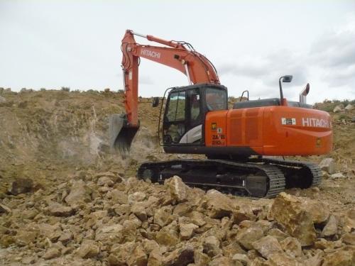 The trackhoe, without which we would not have collected very much.  Approximately every half  hour or so Foster scrapes rock off of some of the walls of the pit, usually exposing a lot of pockets. (Author: John S. White)