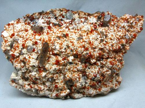 Spessartine with smoky Quartz on Feldspar
Yunxiao, Zhangzhou, Fujian, China
8×17×25 cm
 (Author: chinamineral)