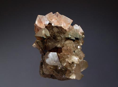 Fluorite
Argentière Glacier, Mont Blanc, Chamonix, Haute-Savoie, France
4.2 x 5.7 cm
Pale pink octahedral fluorite crystals to 1.1 cm on edge sitting atop chlorite coated fluorite and smoky quartz crystals. (Author: crosstimber)