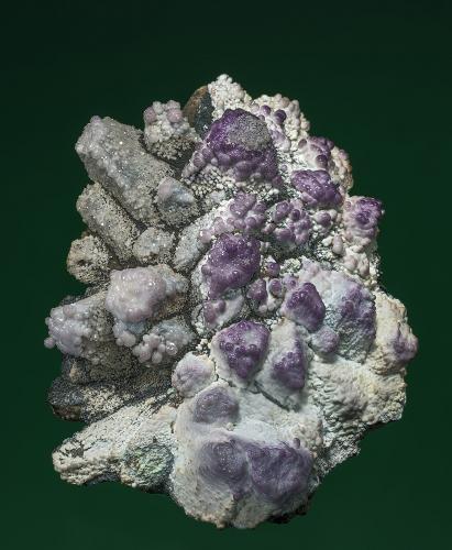 Fluorite
Maria Mine, Sounion Area, Lavrion District Mines, Attikí Prefecture, Greece
7.3 x 9.5 cm
Clear to purple fluorites along with what appears to be botryoidal aragonite on an unknown calcite(?) epimorph/pseudomorph. (Author: am mizunaka)