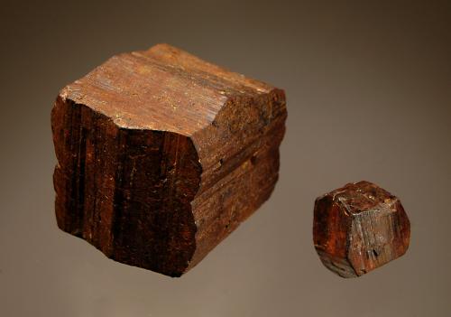 Limonite ps. after pyrite
Schwartz Farm, Fruitville, Lancaster Co., Pennsylvania, USA
Left xl. 3.5 cm, right xl. 1.5 cm
A somewhat distorted cube with prominent striations and a smaller but slightly more lustrous pyritohedron. (Author: crosstimber)