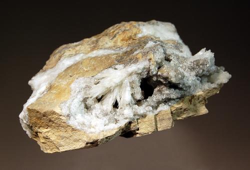 Strontianite
Meckley Quarry, Mandata, Northumberland Co., Pennsylvania, USA
5.0 x 6.3 cm
Typical cavity in laminated Tonoloway limestone lined with snow white strontianite, calcite and celestine. This is a classic latter paragenesis from this quarry.  Exhibits cream-white fluorescence under SW UV. (Author: crosstimber)