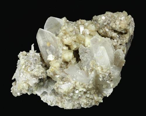 Woodhouseite on Quartz
Champion Mine, White Mts., Mono County, California, USA
70 x 45 x 42 mm

Plate of clear to translucent Quartz crystals to 25 x 10 mm is covered by hundreds of lustrous, translucent, tan crystals of Woodhousite to 4.5 mm. The reverse side of the specimen is preferentially coated. In perfect condition. (Author: GneissWare)