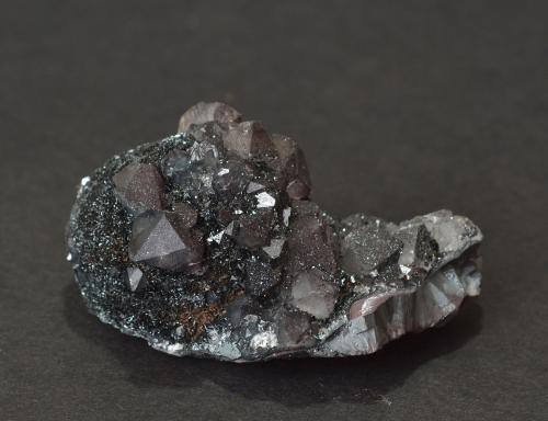 Quartz (var. smokey) on hematite (var. specularite) on plate
Haile Moor Mine, Haile, Egremont, Cumbria, England, UK
5.8 x 2.9 x 3.0 cm
other side (Author: captaincaveman)