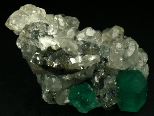 Beryl (variety emerald), Calcite<br />La Pita mining district, Cunas Mine, Municipio Maripí, Western Emerald Belt, Boyacá Department, Colombia<br />60x50x35mm<br /> (Author: Fiebre Verde)