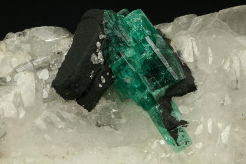 Beryl (variety emerald), Calcite<br />Muzo mining district, Western Emerald Belt, Boyacá Department, Colombia<br />60x45x28mm<br /> (Author: Fiebre Verde)