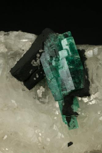 Beryl (variety emerald), Calcite<br />Muzo mining district, Western Emerald Belt, Boyacá Department, Colombia<br />60x45x28mm<br /> (Author: Fiebre Verde)