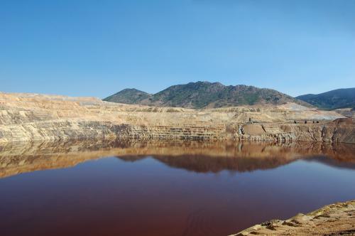 The Berkeley Pit was opened in 1955 and closed in 1982. It is 1,780 feet deep and is filled to a depth of 975  feet with acidic water. (Author: crosstimber)