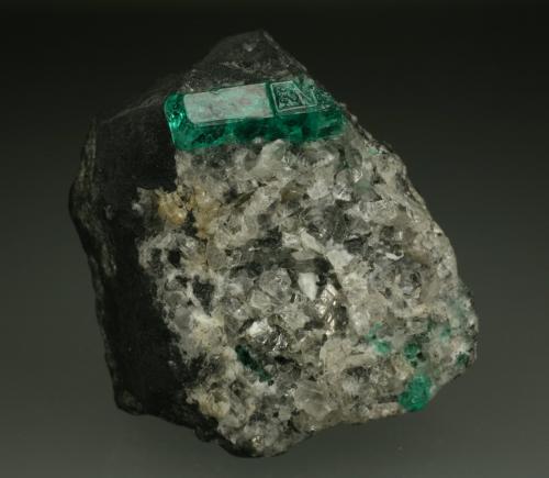 Beryl (variety emerald), Calcite<br />La Pita mining district, Municipio Maripí, Western Emerald Belt, Boyacá Department, Colombia<br />40mm across, xl=15mm<br /> (Author: Fiebre Verde)