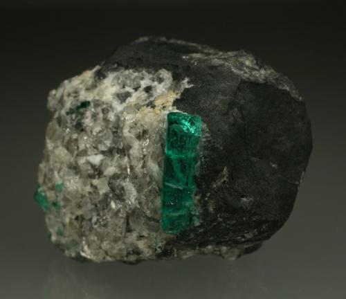 Beryl (variety emerald), Calcite<br />La Pita mining district, Municipio Maripí, Western Emerald Belt, Boyacá Department, Colombia<br />40mm across, xl=15mm<br /> (Author: Fiebre Verde)