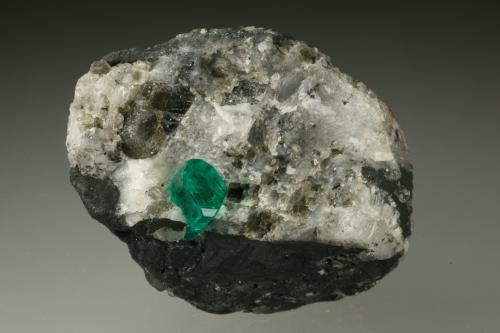 Beryl (variety emerald), Calcite, Pyrite<br />Chivor mining district, Municipio Chivor, Eastern Emerald Belt, Boyacá Department, Colombia<br />35x45mm, xl=6mm<br /> (Author: Fiebre Verde)