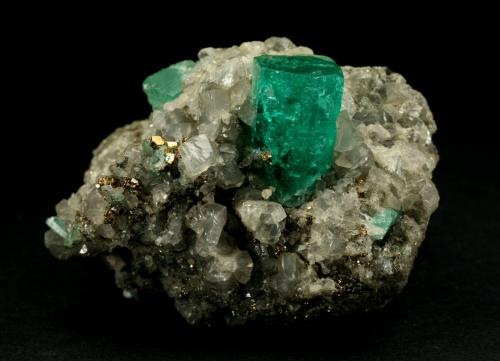 Beryl (variety emerald), Calcite, Pyrite<br />Muzo mining district, Western Emerald Belt, Boyacá Department, Colombia<br />42x29x30mm<br /> (Author: Fiebre Verde)