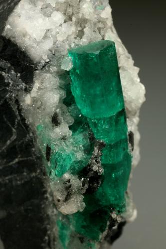 Beryl (variety emerald), Calcite<br />Muzo mining district, Western Emerald Belt, Boyacá Department, Colombia<br />28x51x49mm, xl=30mm<br /> (Author: Fiebre Verde)