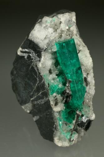 Beryl (variety emerald), Calcite<br />Muzo mining district, Western Emerald Belt, Boyacá Department, Colombia<br />28x51x49mm, xl=30mm<br /> (Author: Fiebre Verde)