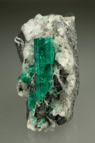 Beryl (variety emerald), Calcite<br />Muzo mining district, Western Emerald Belt, Boyacá Department, Colombia<br />28x51x49mm, xl=30mm<br /> (Author: Fiebre Verde)