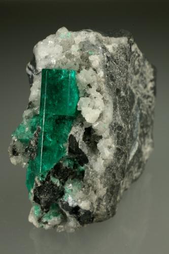 Beryl (variety emerald), Calcite<br />Muzo mining district, Western Emerald Belt, Boyacá Department, Colombia<br />28x51x49mm, xl=30mm<br /> (Author: Fiebre Verde)