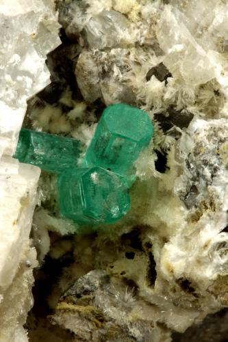 Beryl (variety emerald), Calcite, Aragonite<br />Chivor mining district, Municipio Chivor, Eastern Emerald Belt, Boyacá Department, Colombia<br />75x55x65mm, main xl~1cm<br /> (Author: Fiebre Verde)