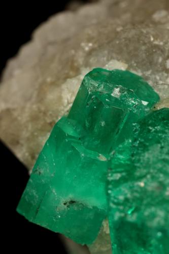 Beryl (variety emerald), Calcite<br />Muzo mining district, Western Emerald Belt, Boyacá Department, Colombia<br />60x47x49mm, central xl=16mm<br /> (Author: Fiebre Verde)