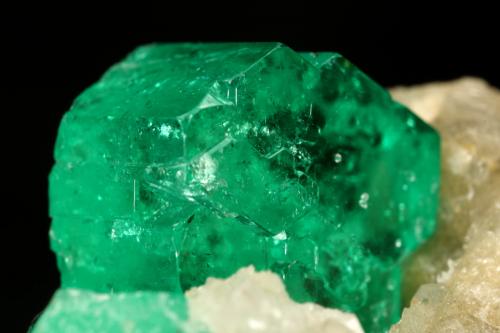 Beryl (variety emerald), Calcite<br />Muzo mining district, Western Emerald Belt, Boyacá Department, Colombia<br />60x47x49mm, central xl=16mm<br /> (Author: Fiebre Verde)